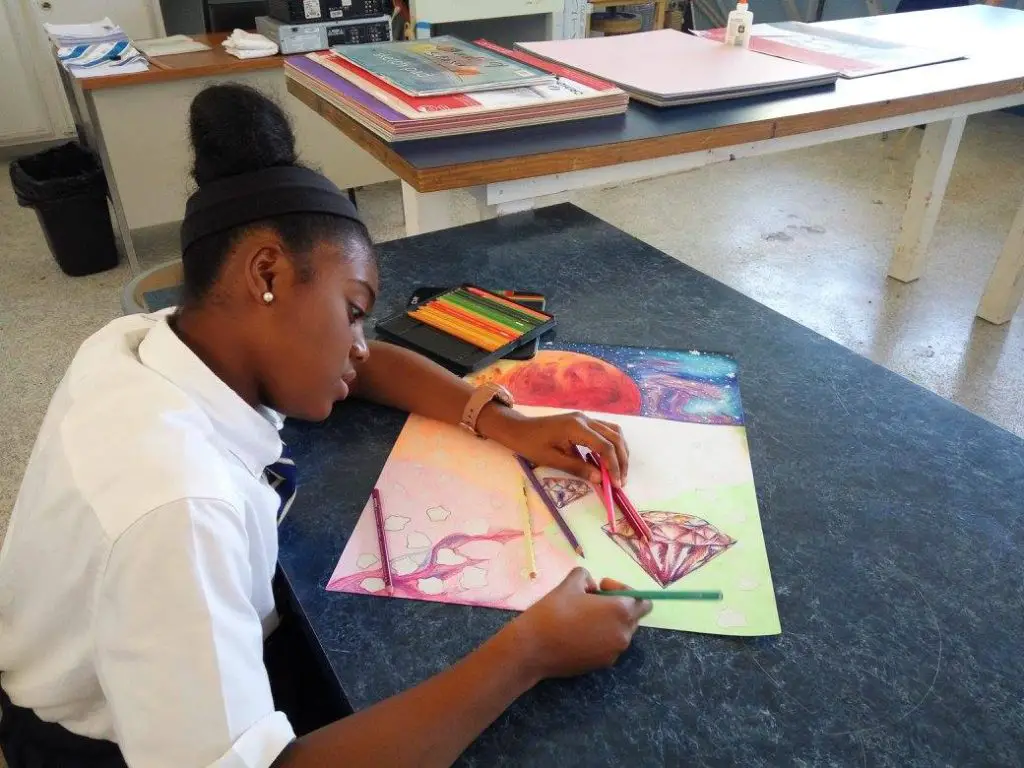 A student working with colored pencil