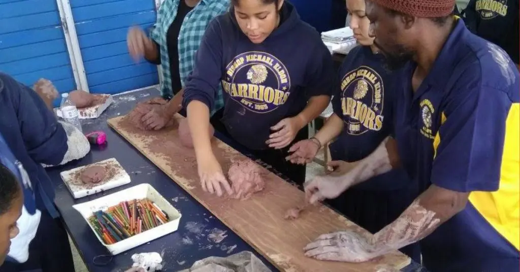 Teacher and students working with clay