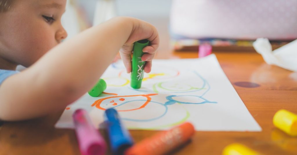 Boy drawing with crayon