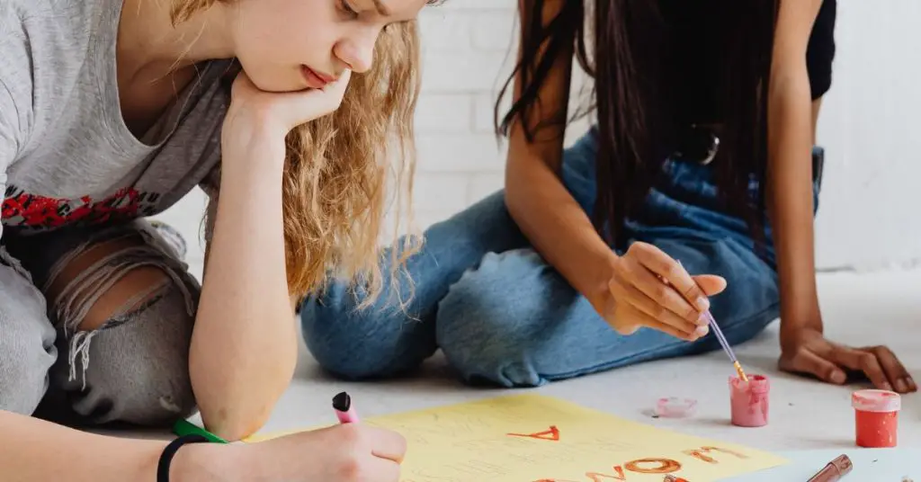 Two art students painting