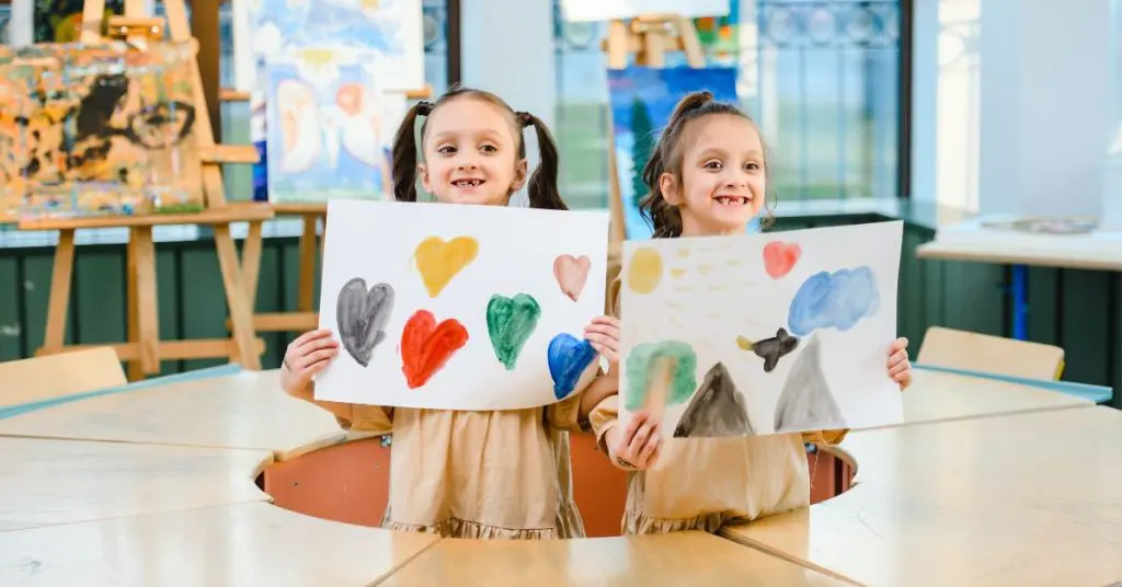 Two art students with their work