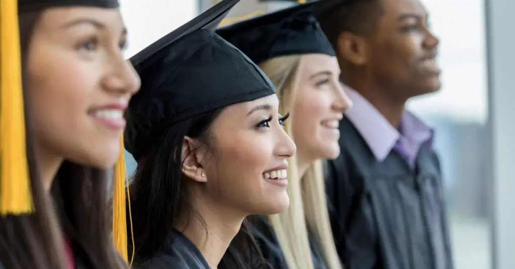 A diverse group of educational icons and symbols surround an open book with a graduation cap on top. What Is Master Of Arts In Education